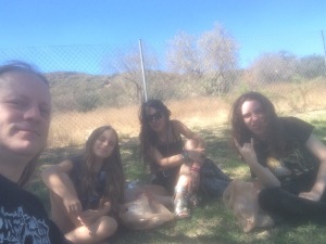 The fam relaxes on a grassy knoll away from the insanity.